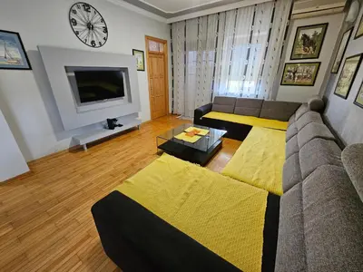 a living room with a couch and a tv at Zora apartment in Belgrade
