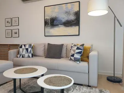 a living room with a couch and two tables at A Blok Exclusive Suite with garage in Belgrade