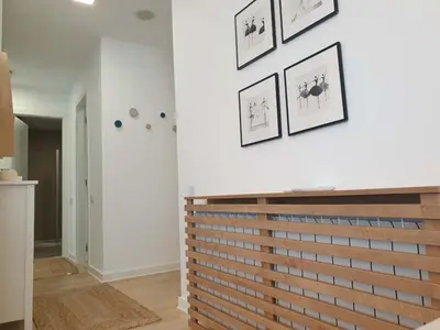 a room with white walls with pictures on the wall at A Blok Exclusive Suite with garage in Belgrade