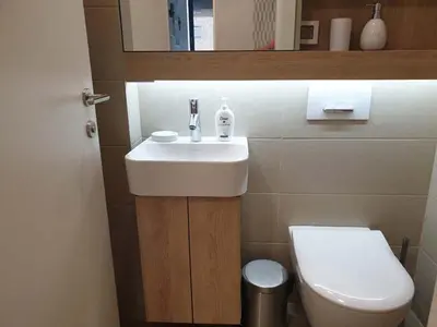 a bathroom with a sink and a toilet at A Blok Exclusive Suite with garage in Belgrade