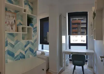 a room with a desk and a chair and windows at A Blok Exclusive Suite with garage in Belgrade