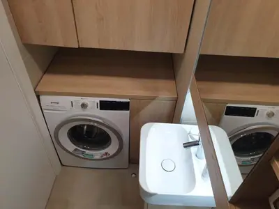 a small bathroom with a washing machine and a sink at A Blok Exclusive Suite with garage in Belgrade