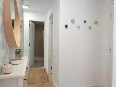 a white bathroom with a sink and a mirror at A Blok Exclusive Suite with garage in Belgrade