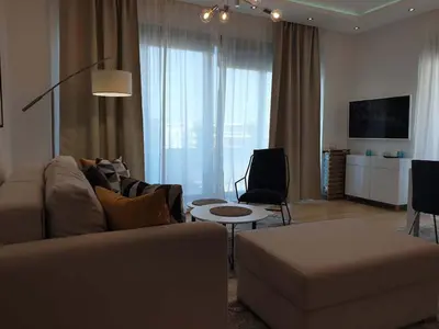 a living room with a couch and a table at A Blok Exclusive Suite with garage in Belgrade