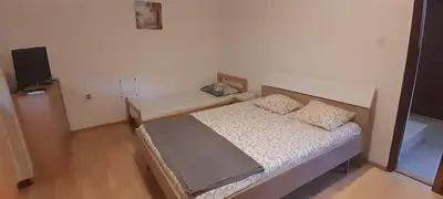 a small bedroom with a bed and a television at Airport Nikki Apartments in Belgrade