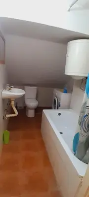 a bathroom with a tub and a toilet and a sink at Airport Nikki Apartments in Belgrade
