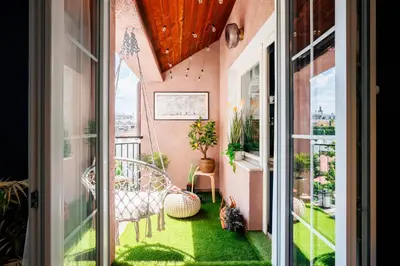 a balcony with green grass and a cat sitting on the floor at Heart Strings with Terrace 290 Mbps Old Town in Belgrade