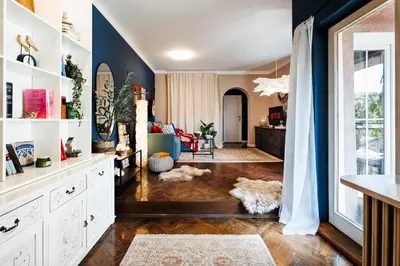 a living room with blue walls and wooden floors at Heart Strings with Terrace 290 Mbps Old Town in Belgrade
