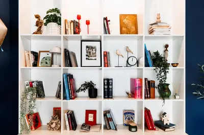 a white book shelf filled with books at Heart Strings with Terrace 290 Mbps Old Town in Belgrade