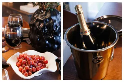 a table with a bucket of grapes and a bottle of wine at Heart Strings with Terrace 290 Mbps Old Town in Belgrade