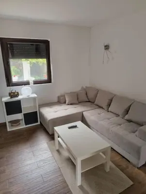 a living room with a couch and a coffee table at IN Zemun Gardos Apartment in Belgrade