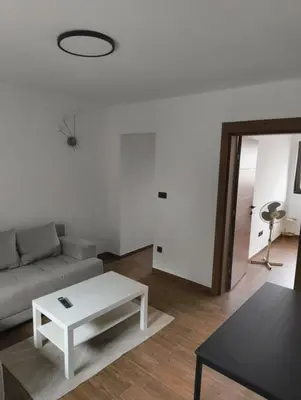 a living room with a couch and a table at IN Zemun Gardos Apartment in Belgrade