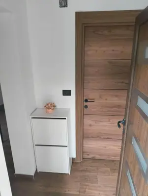 a room with a door and a table with a plant on it at IN Zemun Gardos Apartment in Belgrade