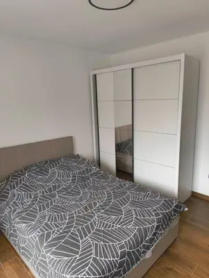 a bedroom with a bed and a dresser at IN Zemun Gardos Apartment in Belgrade