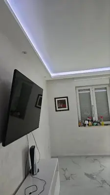 a living room with a flat screen tv on a wall at Lava's Lux in Belegiš
