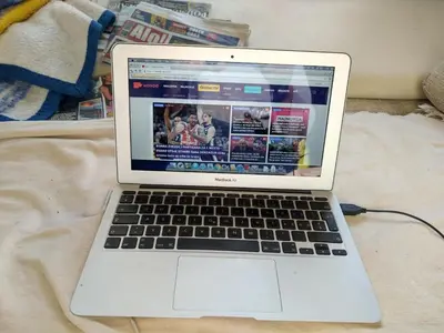 a laptop computer sitting on top of a bed at Lava's Lux in Belegiš