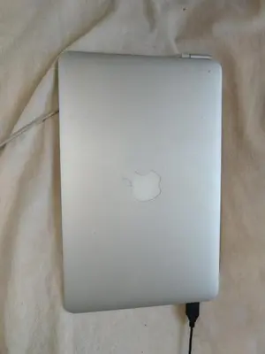 a white laptop computer sitting on top of a table at Lava's Lux in Belegiš