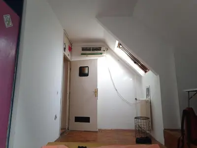 a hallway with a white wall and a white door at Art studio Banjica in Belgrade