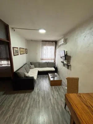 a living room with a couch and a table at Apartman Selena in Belgrade