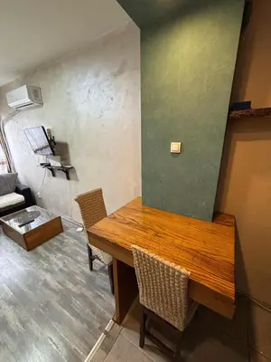 a dining room with a wooden table and chairs at Apartman Selena in Belgrade
