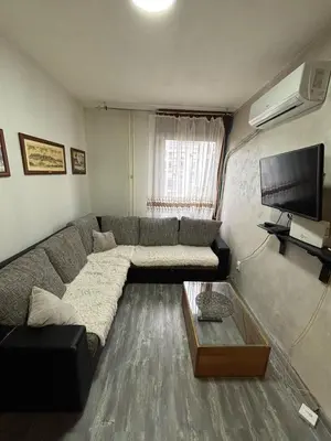 a living room with a couch and a flat screen tv at Apartman Selena in Belgrade