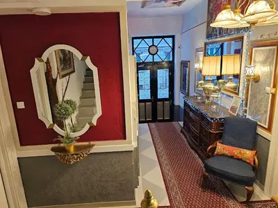 a hallway with a mirror and a chair in a room at Belgrade Luxury Suite 23 in Belgrade