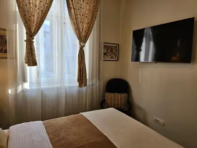 a bedroom with a bed and a window with a television at Belgrade Luxury Suite 23 in Belgrade