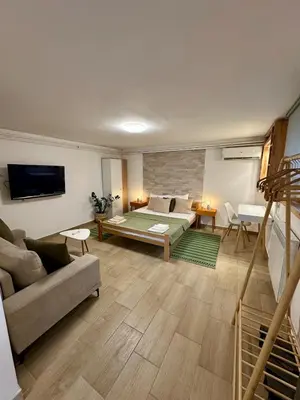 a living room with a couch and a tv and a couch at M Place in Mirijevo