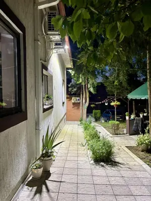 a walkway with potted plants on the side of a building at M Place in Mirijevo