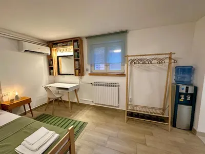 a room with a table and a desk in it at M Place in Mirijevo