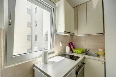 a small kitchen with a sink and a window at Sekula's City Center Apartment in Belgrade
