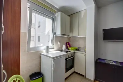 a small kitchen with a sink and a window at Sekula's City Center Apartment in Belgrade
