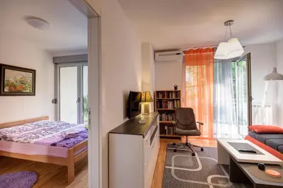 a bedroom with a bed and a desk with a chair at Sekula's City Center Apartment in Belgrade