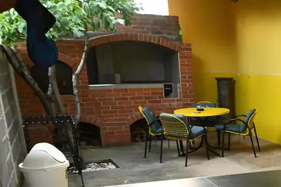 a table and chairs in front of a brick oven at Kod kapetana in Smederevo