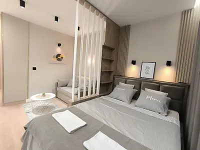 a bedroom with a large bed with two pillows at Gallery-mall Studio Belgrade Waterfont in Belgrade