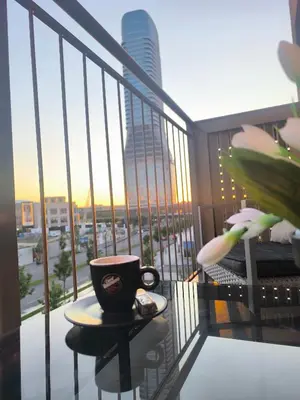 a coffee cup sitting on a table on a balcony at Gallery-mall Studio Belgrade Waterfont in Belgrade