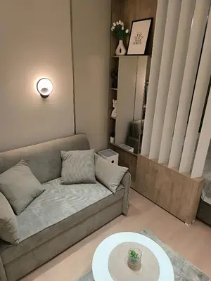 a living room with a couch and a table at Gallery-mall Studio Belgrade Waterfont in Belgrade