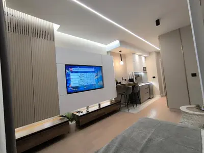 a living room with a flat screen tv on a wall at Gallery-mall Studio Belgrade Waterfont in Belgrade
