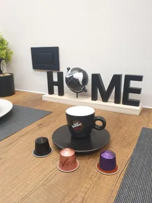 a coffee cup and saucers on the floor in a living room at Gallery-mall Studio Belgrade Waterfont in Belgrade