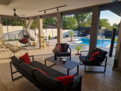 a living room with a couch and chairs and a table at Elin House in Inđija