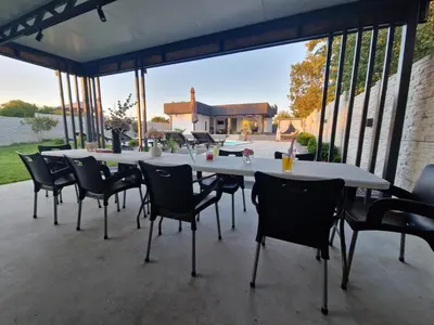 a group of tables and chairs on a patio at Elin House in Inđija