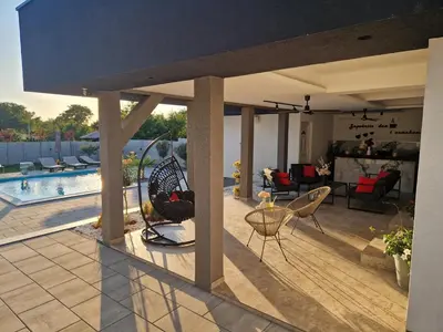 a patio with chairs and a swimming pool at Elin House in Inđija
