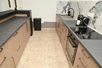 a kitchen with wooden cabinets and gray counter tops at Elin House in Inđija