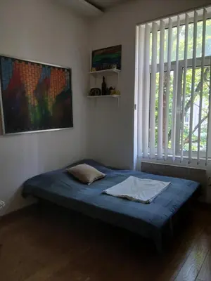 a bed in a room with a large window at Luna in Belgrade