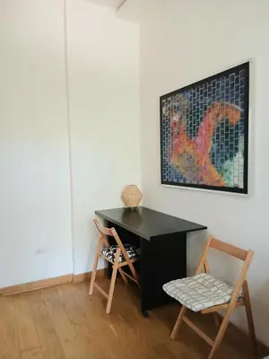 a black desk and two chairs in a room at Luna in Belgrade