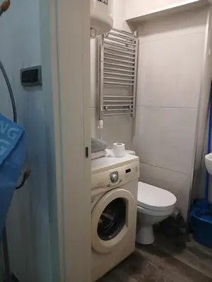 a bathroom with a washing machine and a toilet at Luna in Belgrade
