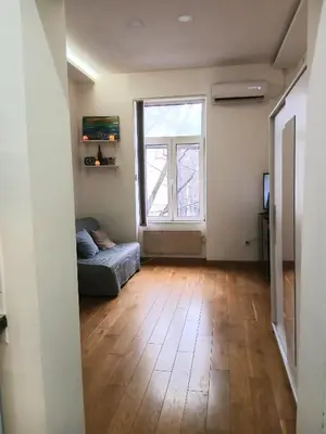 an empty living room with a couch and a window at Luna in Belgrade