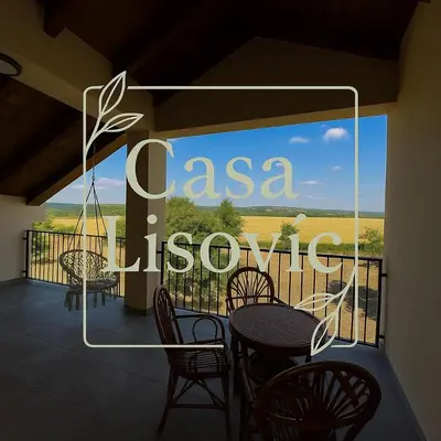 a balcony with a table and chairs and a view at Casa Lisović in Lisović