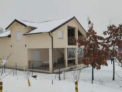 a house with snow on top of it at Casa Lisović in Lisović