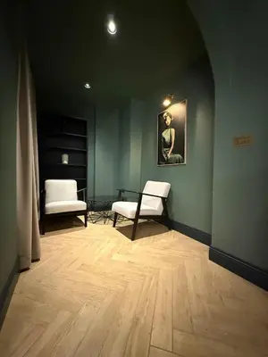 a living room with two chairs and a table at MiVa Apartment in Belgrade